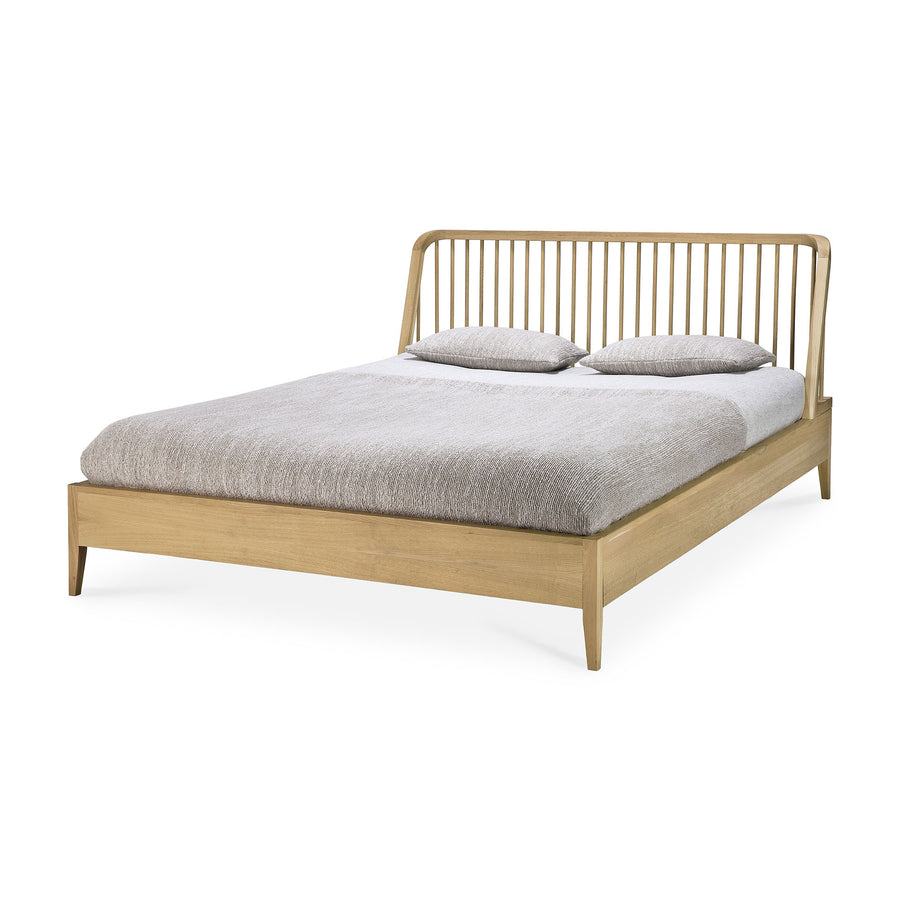 Spindle oak bed by Ethnicraft, three-quarter view