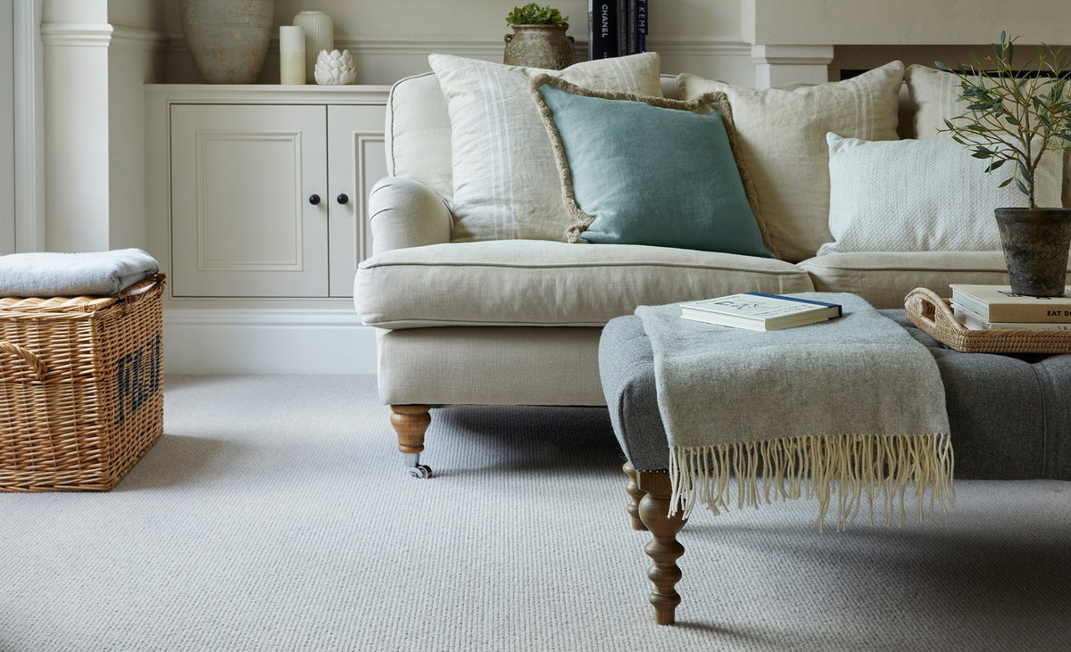Cormar Malabar Two Fold Husk carpet with a pale sofa in a neutral living room — supplier inspiration