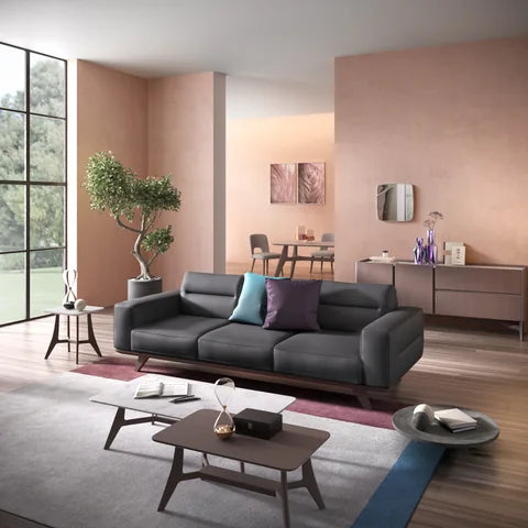 Natuzzi Editions Adrenalina sofa in a warm pink room with wooden flooring and tables