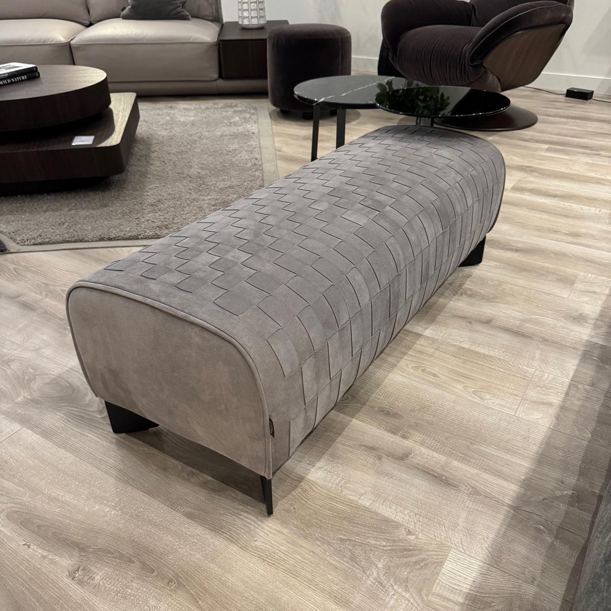 Natuzzi Italia Campus braided leather bench — actual showroom photograph