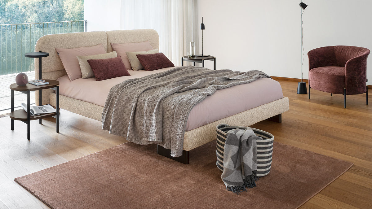 Calligaris Kilian Round bed — upholstered bed in a warm neutral bedroom