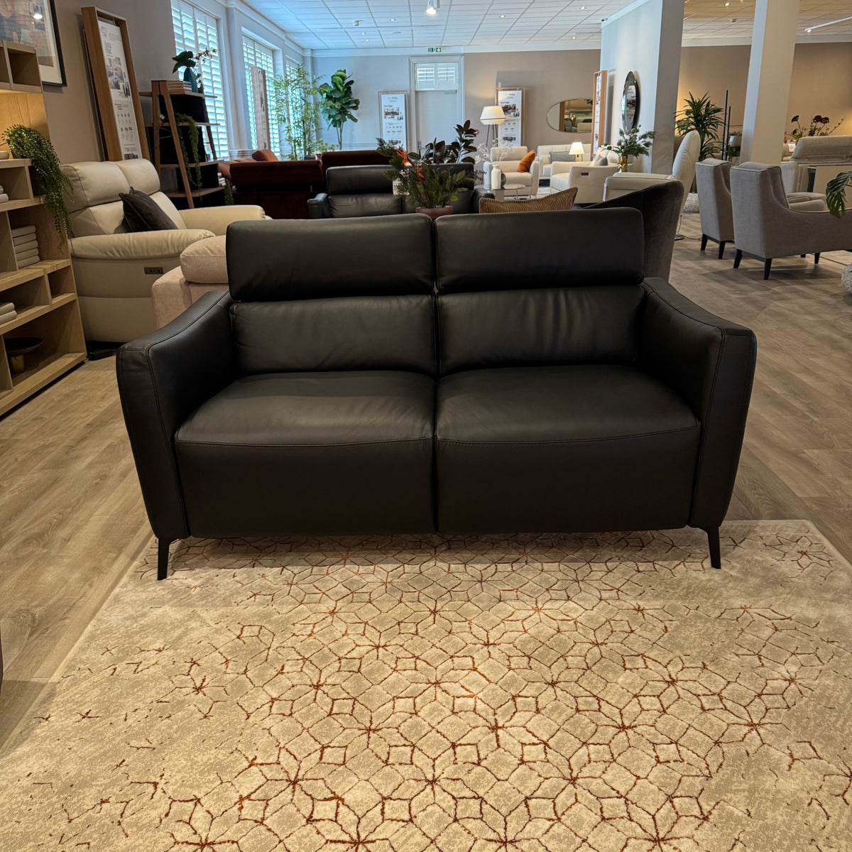 Natuzzi Editions Seattle black leather double power sofa, closed front view. Actual showroom photograph; shared by two matching sofas listed separately. Price is per sofa.