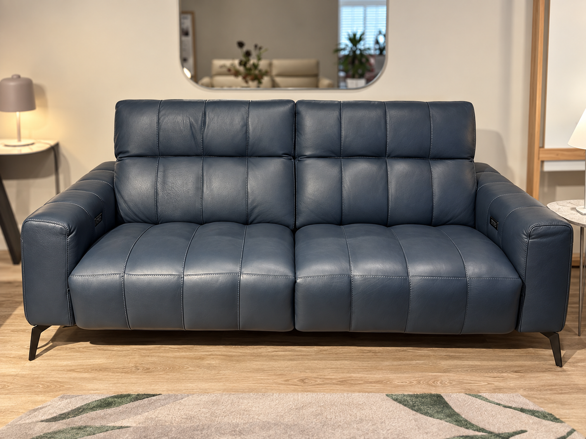 Natuzzi Editions Portento power sofa in Madison Blue Night leather, front view, photographed in the Fultons showroom