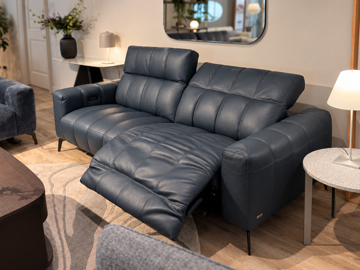 Natuzzi Editions Portento power sofa in Madison Blue Night leather, reclining seat extended, photographed in the Fultons showroom
