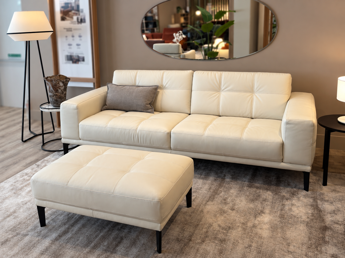 Natuzzi Editions Toledo white leather sofa and stool, angled view, photographed in the Fultons showroom