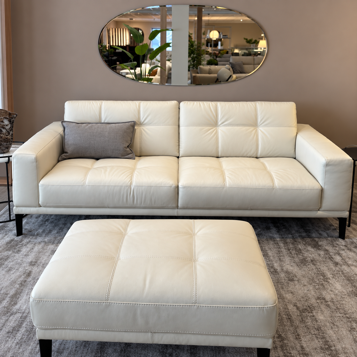 Natuzzi Editions Toledo white leather sofa and stool, front view, photographed in the Fultons showroom