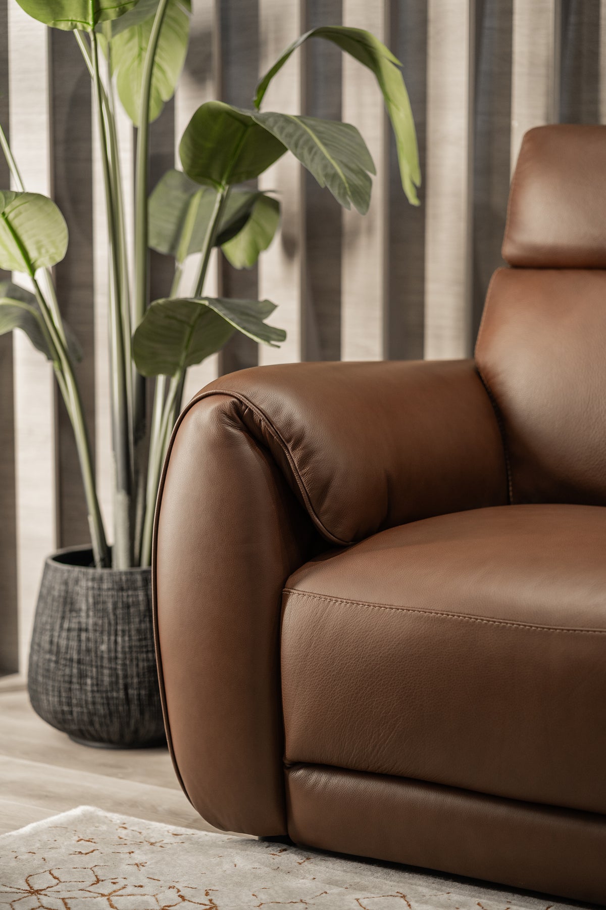 Natuzzi Editions Nuvia sofa in Dream Rawhide leather — close-up of the arm profile, grain and stitching