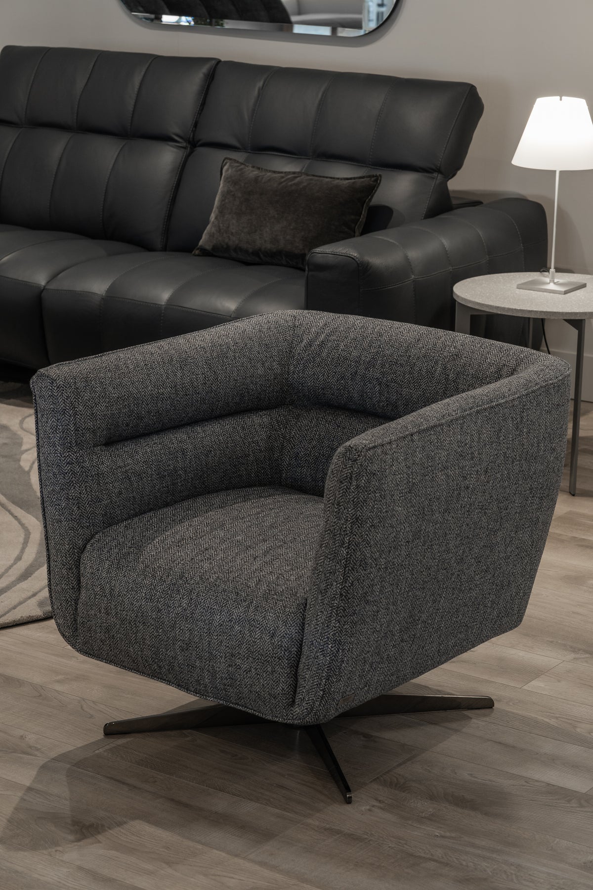 Natuzzi Editions Spiritosa swivel chair in Marte Blue melange fabric with Black Chrome base, in the Fultons showroom
