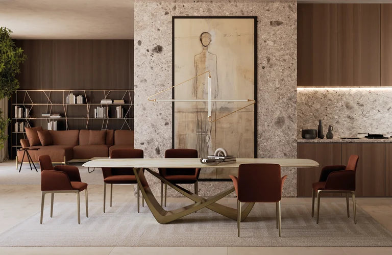Bontempi Bach dining table with a sculptural metal base and upholstered Opera chairs.