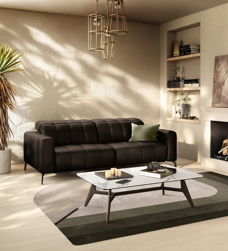 Natuzzi Editions Portento sofa beside a fireplace in a sunlit living room.