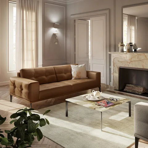 Natuzzi Editions Toledo sofa in tan leather beside a marble fireplace in a light room